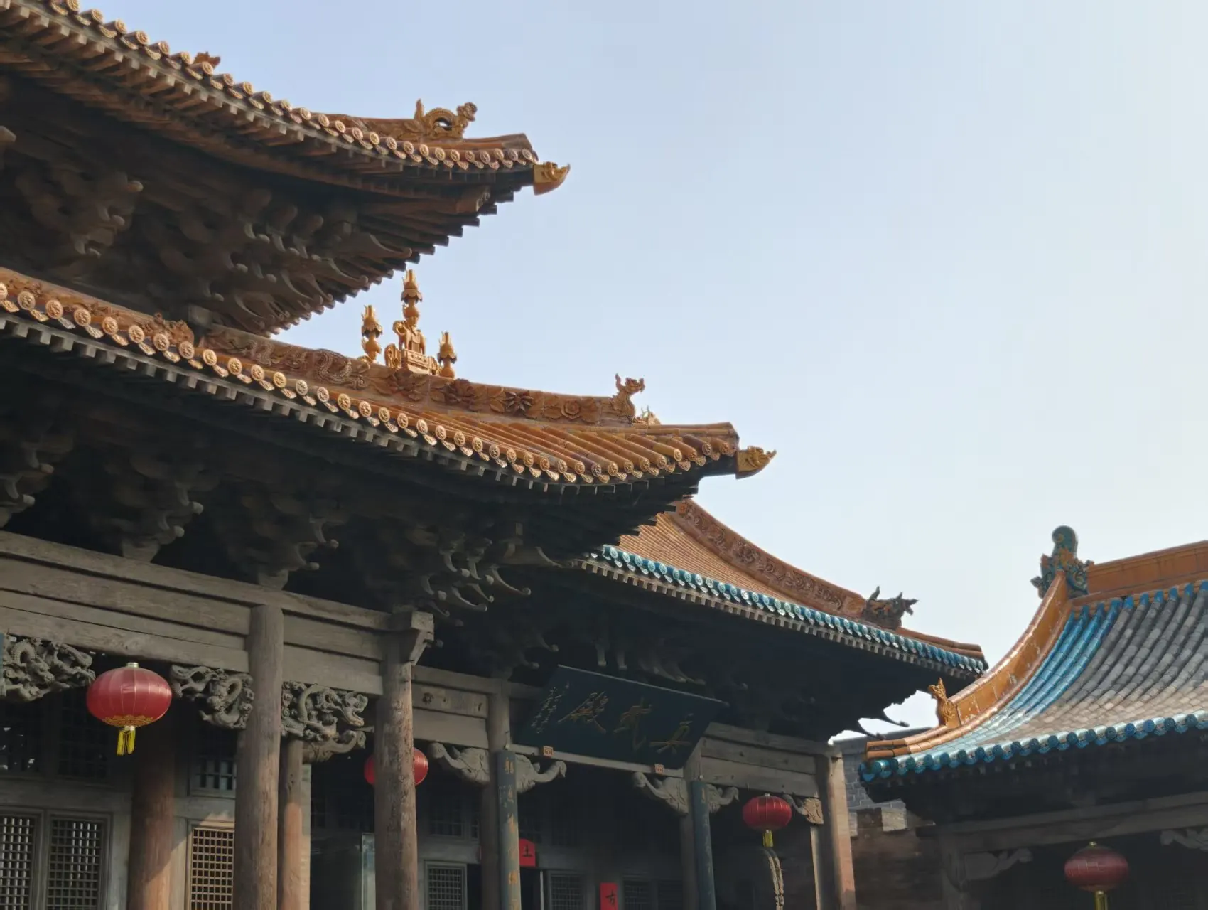 阳光下的古建筑屋顶与红灯笼